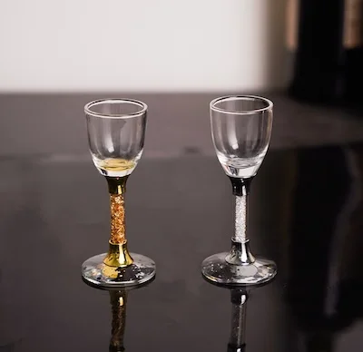 Crystal-detailed shot glasses on a dark tabletop